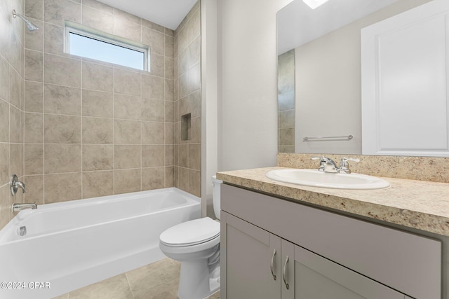 full bathroom featuring vanity, toilet, tiled shower / bath combo, and tile patterned flooring