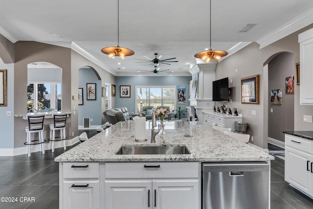 kitchen featuring light stone countertops, dishwasher, white cabinetry, hanging light fixtures, and ceiling fan