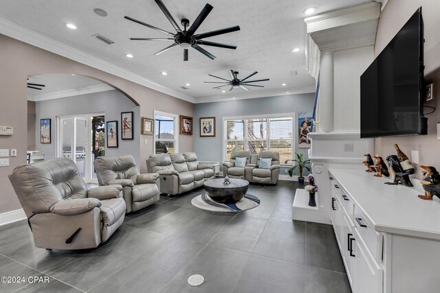 living room featuring ceiling fan and ornamental molding