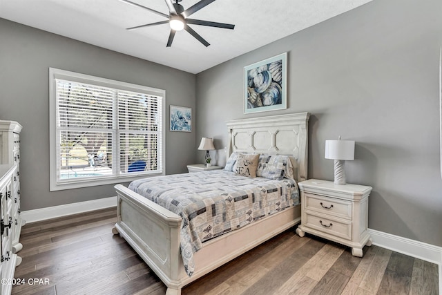 bedroom with ceiling fan and dark hardwood / wood-style flooring