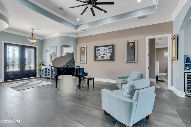 entryway with beverage cooler, french doors, a raised ceiling, ceiling fan, and crown molding