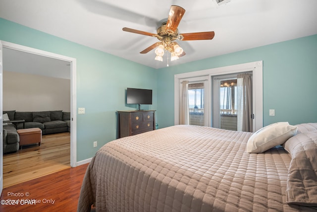 bedroom with access to exterior, hardwood / wood-style flooring, and ceiling fan