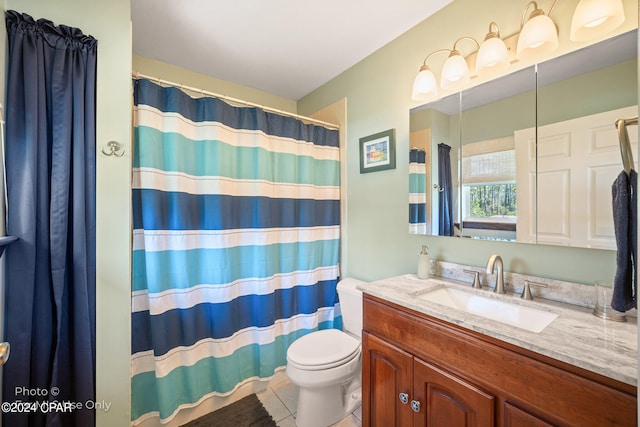 bathroom featuring tile patterned flooring, vanity, and toilet