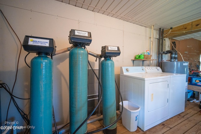 laundry area with independent washer and dryer, light hardwood / wood-style flooring, and water heater