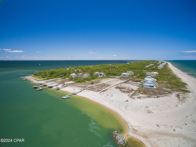 drone / aerial view with a water view and a beach view