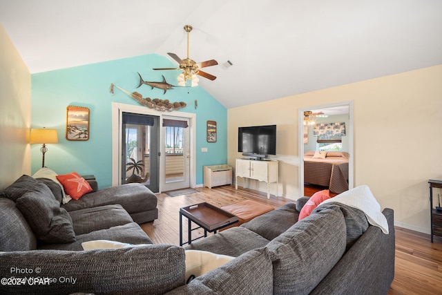 living room featuring ceiling fan, light hardwood / wood-style floors, lofted ceiling, and radiator