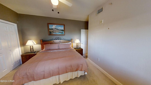 bedroom with light carpet, ceiling fan, and a closet