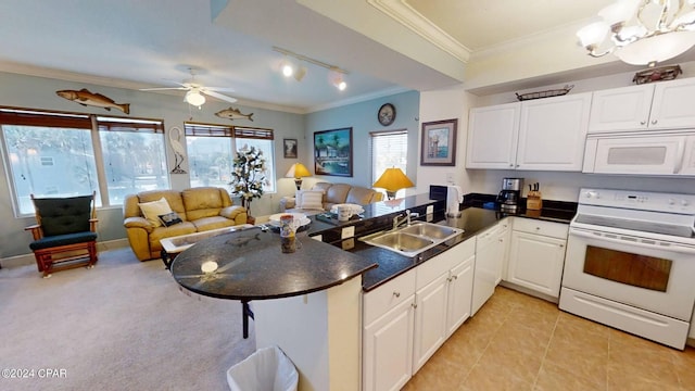 kitchen with white appliances, ceiling fan, sink, and white cabinetry