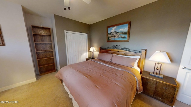 bedroom with light carpet, a closet, and ceiling fan