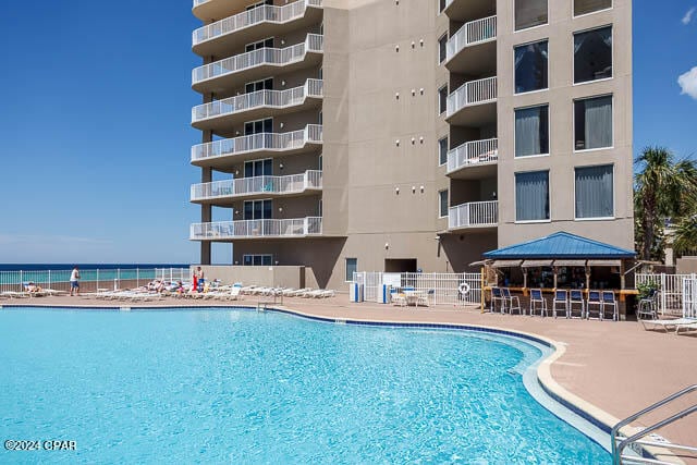 view of pool featuring a gazebo and a water view