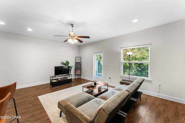 living room featuring ceiling fan and dark hardwood / wood-style floors