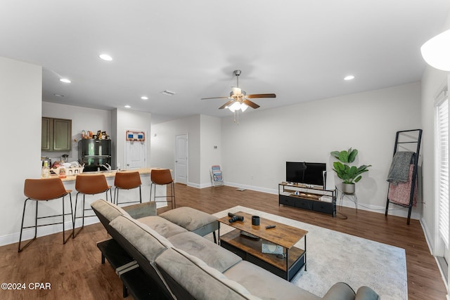 living room with hardwood / wood-style floors and ceiling fan