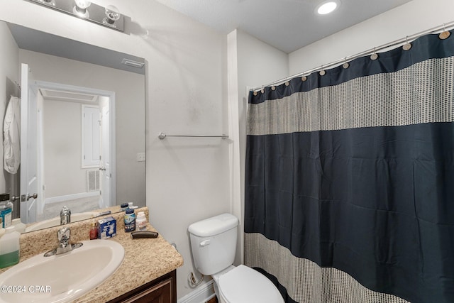 bathroom with a shower with curtain, vanity, and toilet