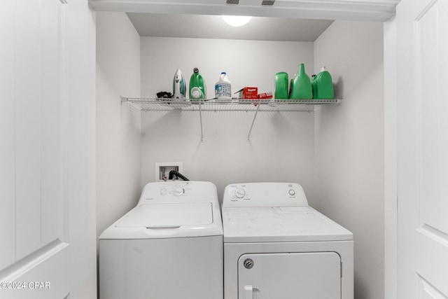 clothes washing area with separate washer and dryer