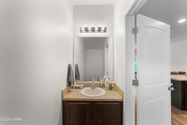 bathroom featuring hardwood / wood-style flooring and vanity