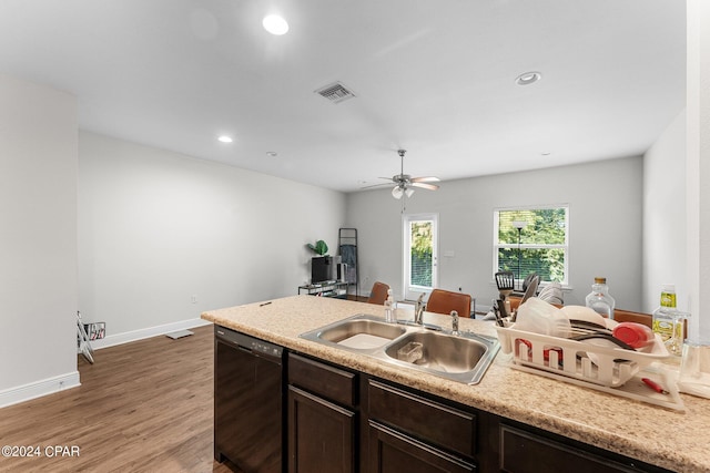 kitchen featuring dark brown cabinetry, sink, wood-type flooring, black dishwasher, and ceiling fan