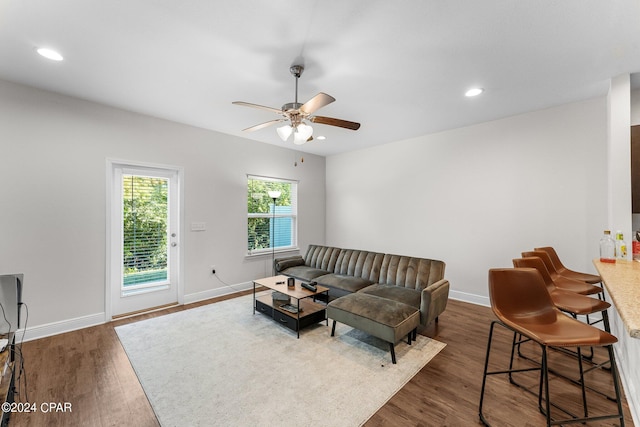 living room featuring dark hardwood / wood-style floors and ceiling fan