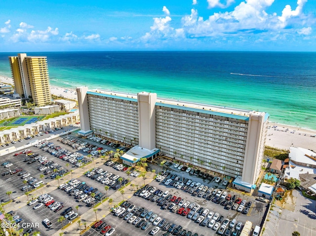 birds eye view of property with a water view and a view of the beach