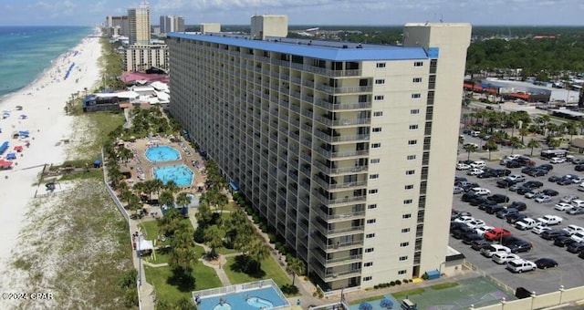 drone / aerial view featuring a water view and a view of the beach