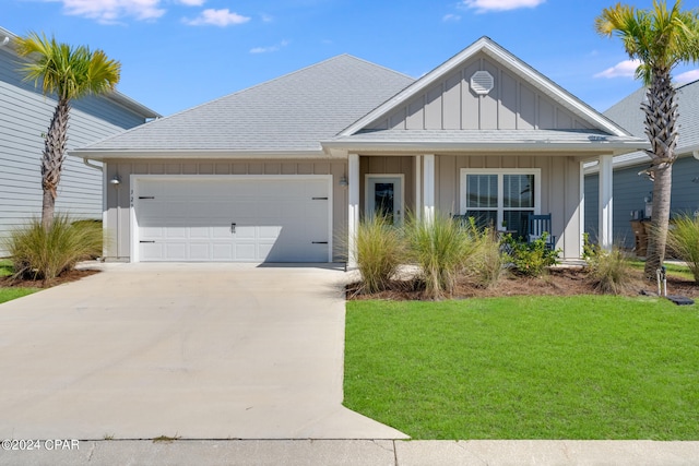 view of front of home with a front lawn and a garage