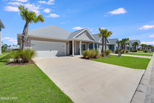 view of front of house with a front yard and a garage