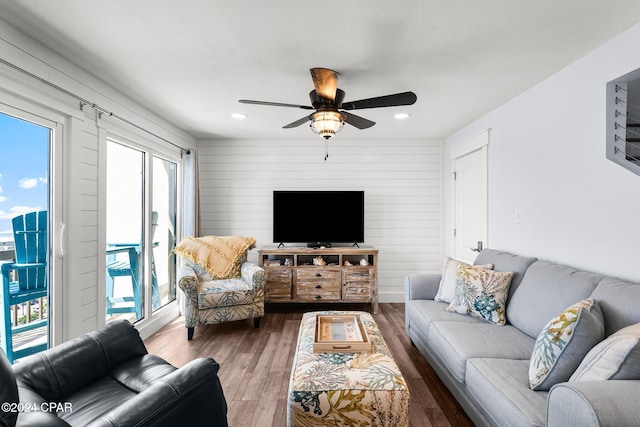 living room with ceiling fan and hardwood / wood-style flooring