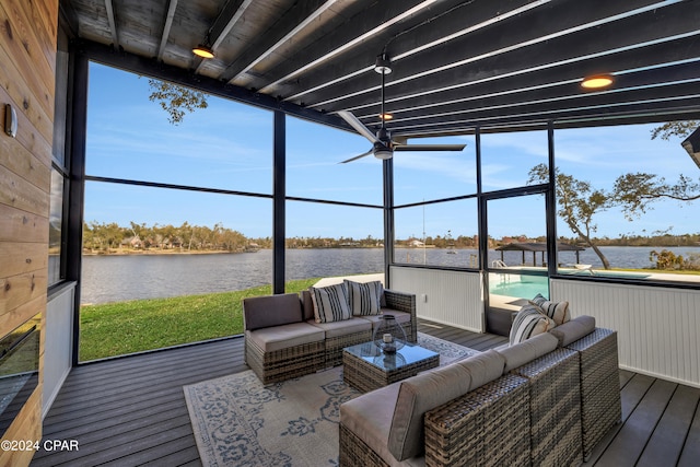 sunroom / solarium featuring track lighting, a water view, and ceiling fan