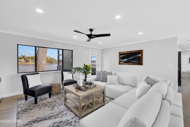 living room featuring crown molding, wood-type flooring, and ceiling fan