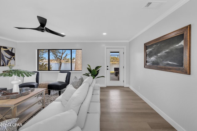 living room featuring ornamental molding, ceiling fan, and hardwood / wood-style floors