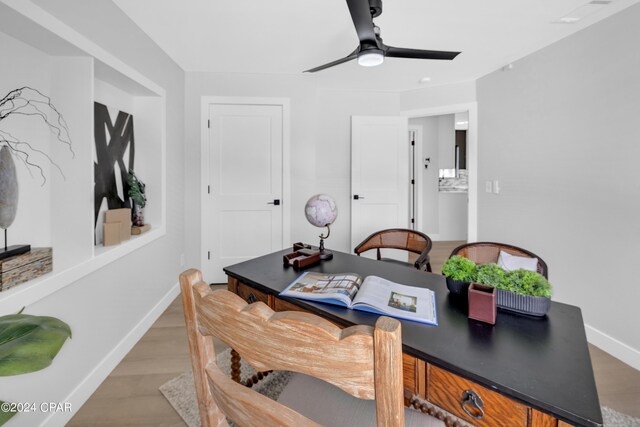 office space with ceiling fan and light hardwood / wood-style flooring