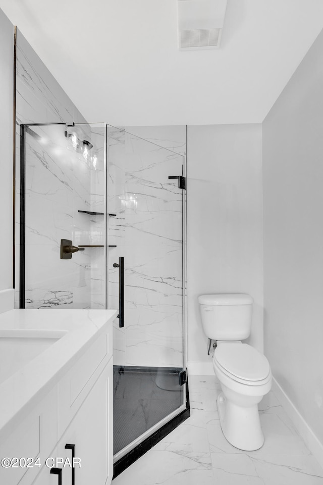 bathroom with an enclosed shower, vanity, and toilet