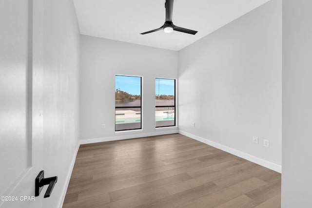 empty room with ceiling fan and light hardwood / wood-style floors