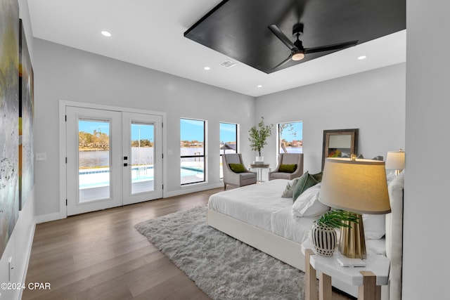 bedroom featuring french doors, hardwood / wood-style floors, access to exterior, and ceiling fan