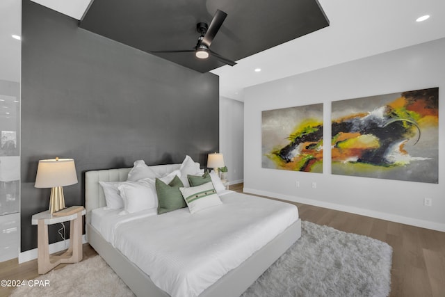 bedroom with ceiling fan and hardwood / wood-style floors