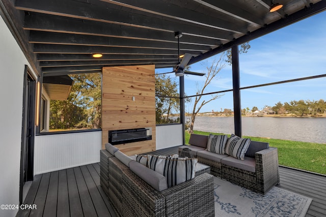 deck with a water view and outdoor lounge area