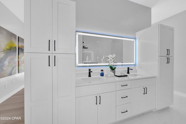 bathroom with a shower with shower door, vanity, and hardwood / wood-style flooring