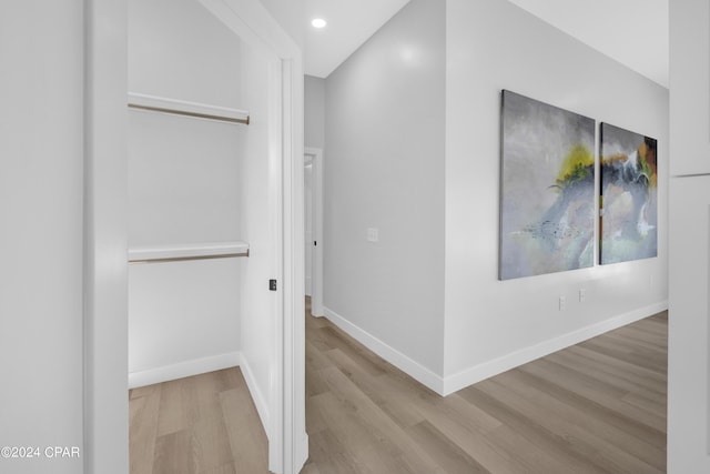 hallway with light hardwood / wood-style floors