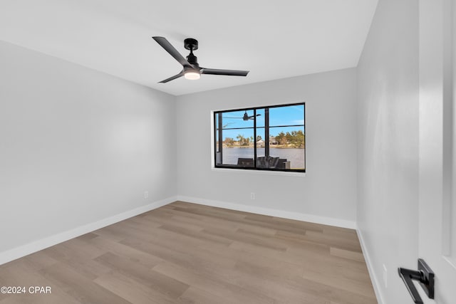 empty room with ceiling fan and light wood-type flooring