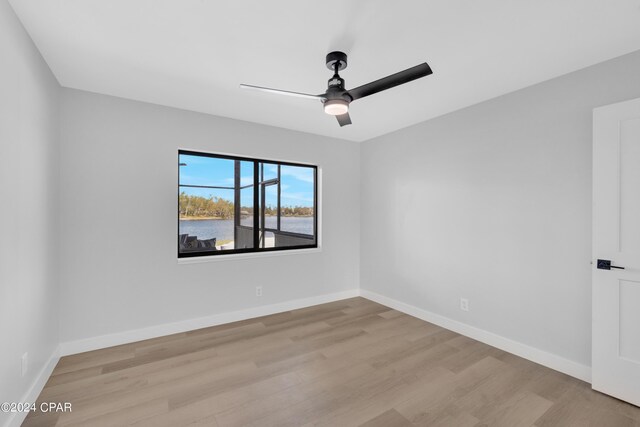 spare room featuring ceiling fan and light hardwood / wood-style floors