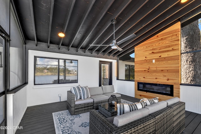 living room with wood walls, lofted ceiling with beams, hardwood / wood-style flooring, and ceiling fan