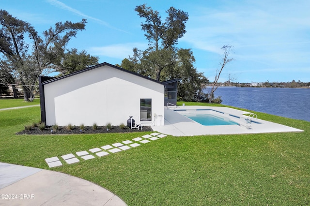 exterior space with a patio, a water view, and a yard