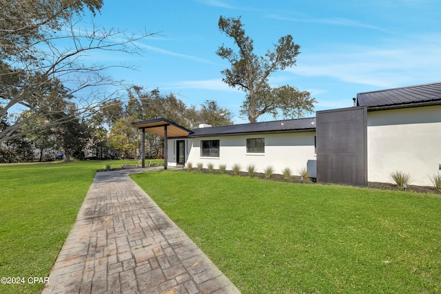 rear view of property featuring a yard