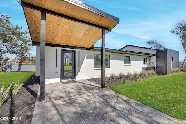 back of house featuring a yard and a patio