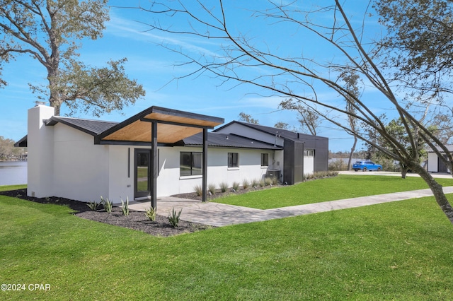 rear view of property with a lawn