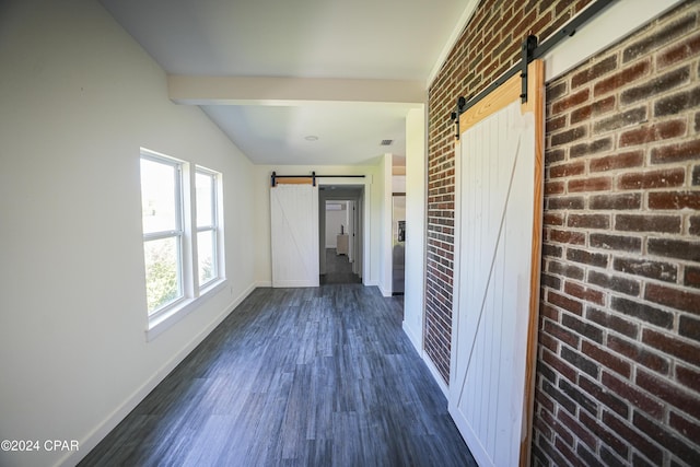corridor with dark wood-type flooring, brick wall, a barn door, and baseboards