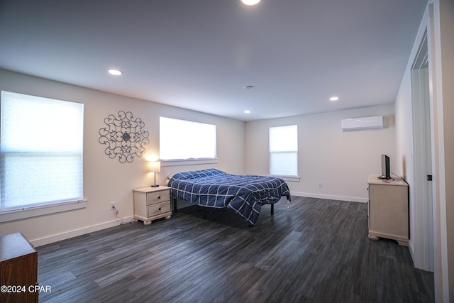 bedroom featuring dark wood finished floors, a wall mounted air conditioner, recessed lighting, and baseboards