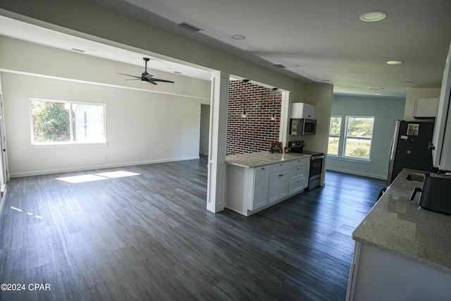 kitchen featuring appliances with stainless steel finishes, white cabinets, and baseboards