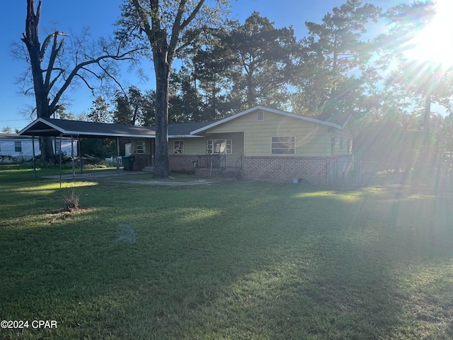 exterior space featuring a carport and a lawn