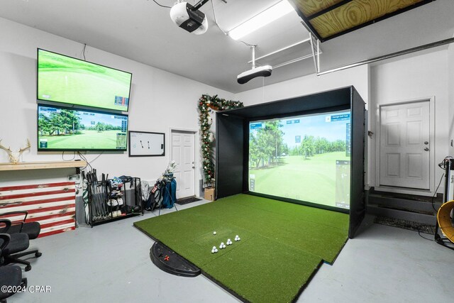 recreation room featuring concrete floors and golf simulator