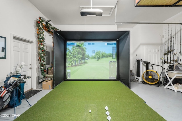 game room with golf simulator and concrete flooring